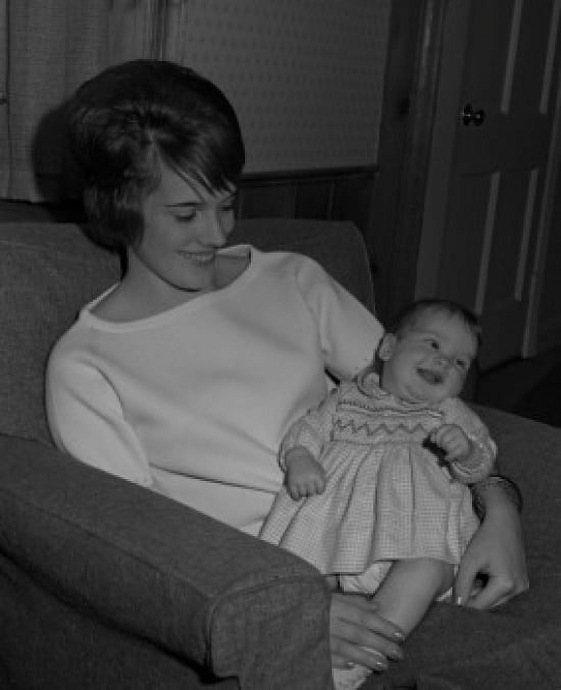 Mother sitting in armchair with baby in arms and smiling Canvas Art - (18 x 24)