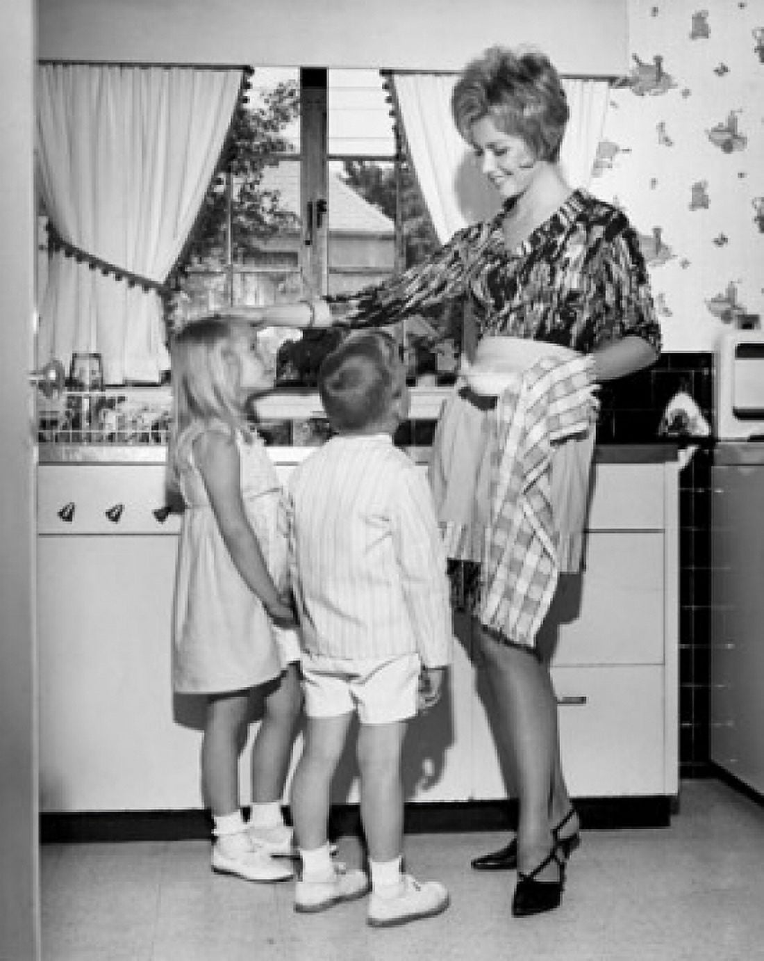 Mother standing with her children in the kitchen Canvas Art - (18 x 24)
