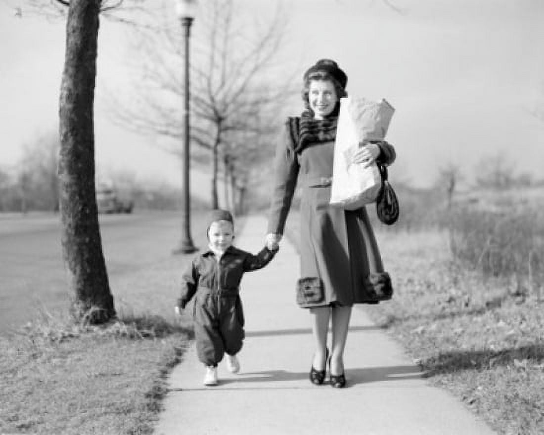 Mother walking with baby daughter along footpath carrying shopping Canvas Art - (18 x 24)