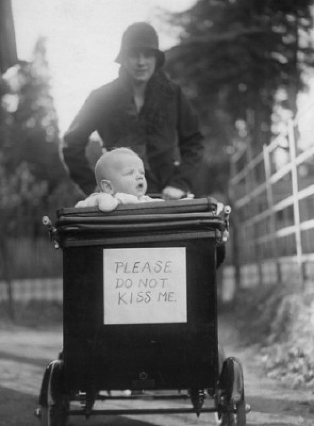 Mother with baby in baby stroller with please do not kiss me placard Canvas Art - (18 x 24)