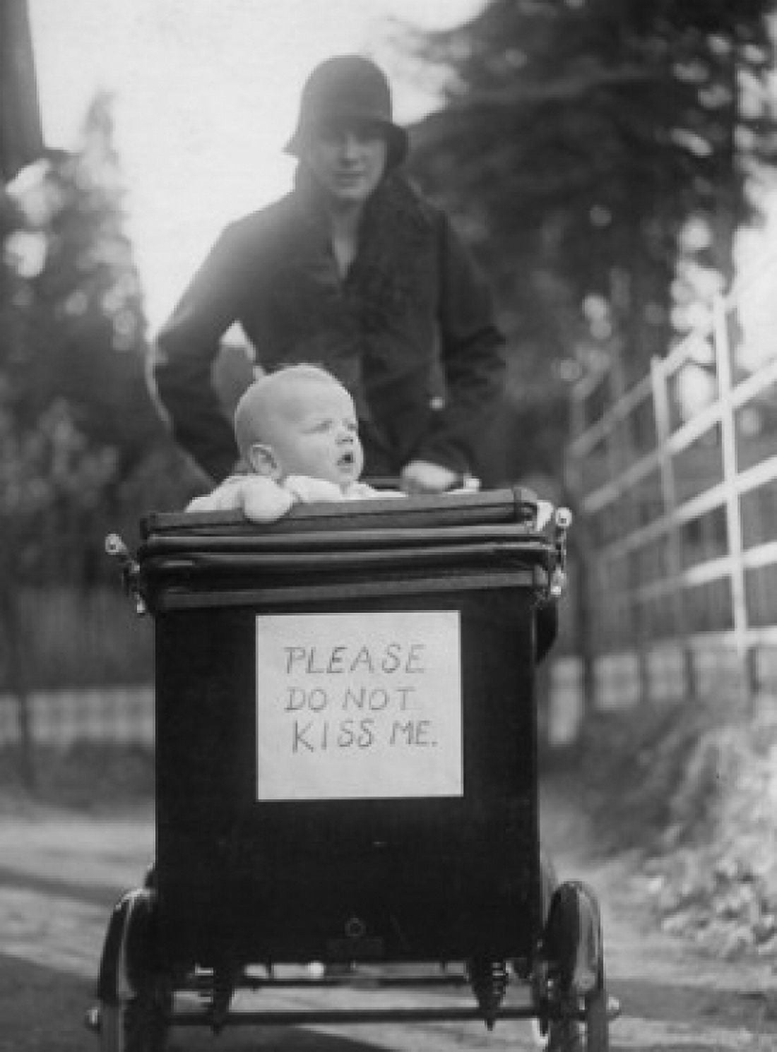 Mother with baby in baby stroller with please do not kiss me placard Canvas Art -  (24 x 36)