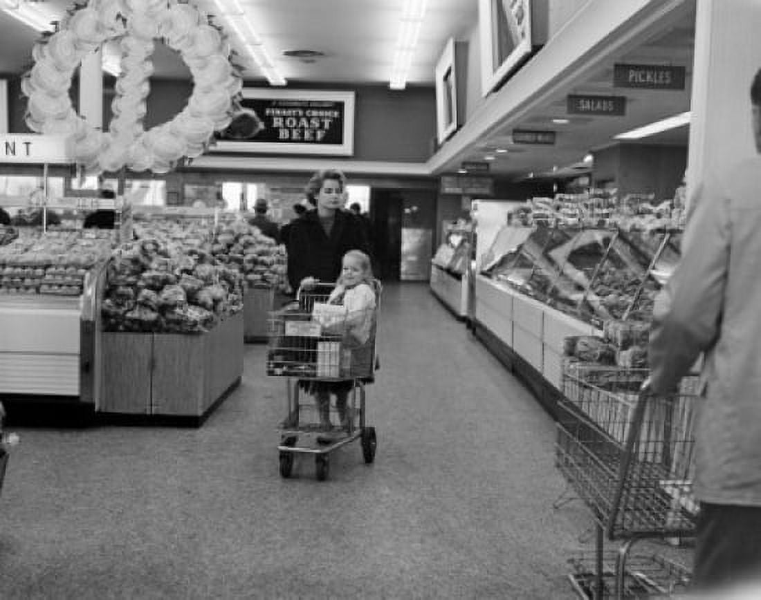 Mother with daughter pulling shopping cart in supermarket Canvas Art - (24 x 36)