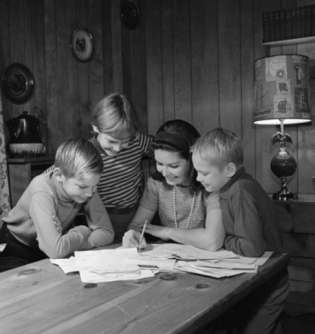 Mother with sons doing homework Canvas Art - (18 x 24)