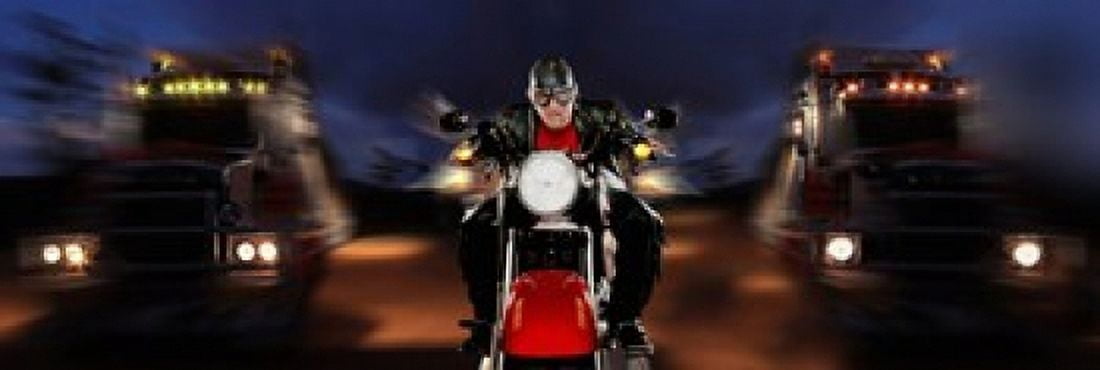 Motorcycle rider between two semi trucks Canvas Art - Panoramic Images (18 x 6)