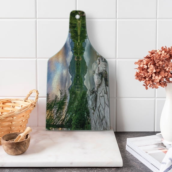 Mountain Cutting Board, Idyllic View with Tree on Still Lake Surrounded by Mountains and Moody Sky Image, Tempered Glass Cutting and Serving Board, Wine Bottle Shape, Multicolor, by Ambesonne