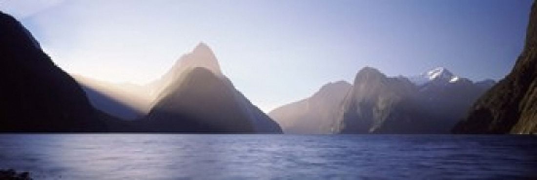 Mountain range at waters edge Milford Sound Fiordland National Park South Island New Zealand Canvas Art - Panoramic Images (18 x 6)
