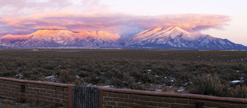 Mountain range viewed from a Adobe brick wall and Sangre De Cristo Mountains New Mexico USA Canvas Art - Panoramic Images (36 x 12)