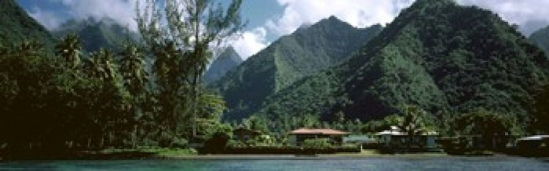 Mountains and buildings at the coast Tahiti Society Islands French Polynesia Canvas Art - Panoramic Images (18 x 6)