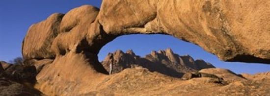 Mountains viewed through a natural arch with a mother holding her baby Spitzkoppe Namib Desert Namibia Canvas Art - Panoramic Images (36 x 13)