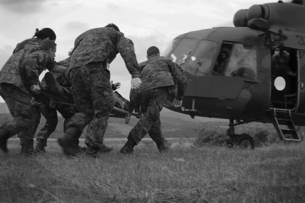 Multinational medical personnel race to a Macedonian MI-17 with a wounded patient Canvas Art - Stocktrek Images (35 x 23)