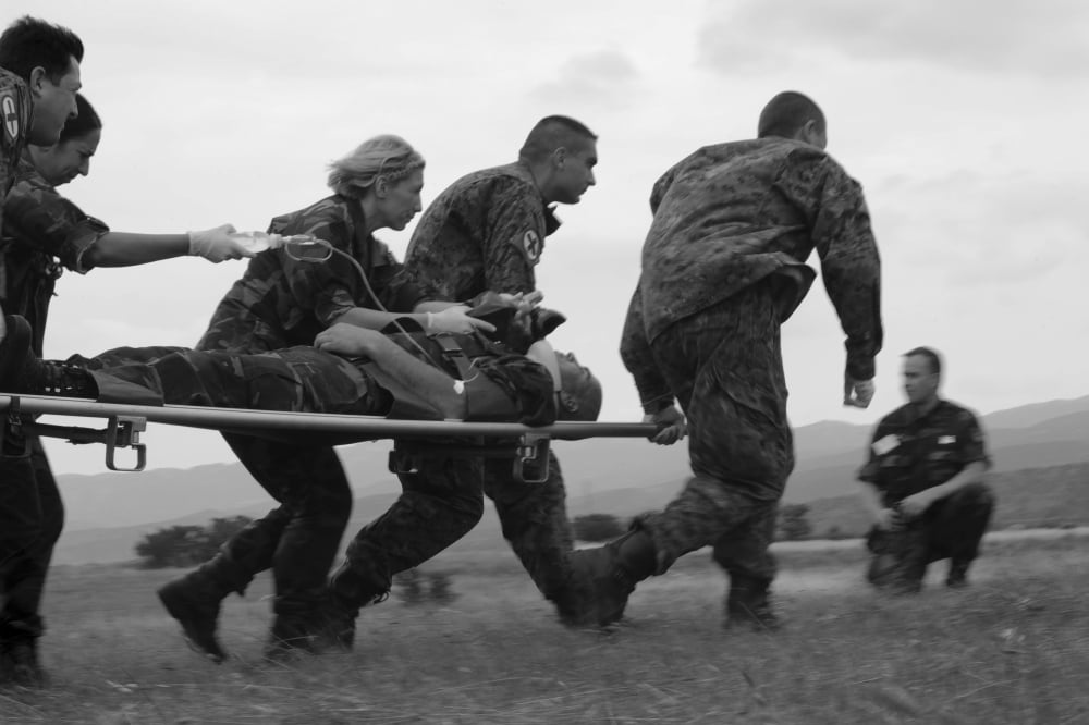 Multinational medical personnel race to a Macedonian MI-17 with a wounded patient Canvas Art - Stocktrek Images (35 x 23)