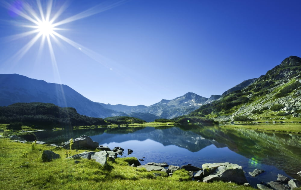 Muratov Lake against blue sky and bright sun in Pirin National Park Bulgaria Canvas Art - Evgeny KuklevStocktrek Images (18 x 12)