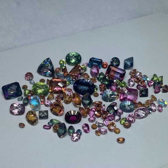 Mystic Topaz wholesale scoops of assorted colors shapes sizes of loose Topaz gemstones in 50ct or 100ct. lots.