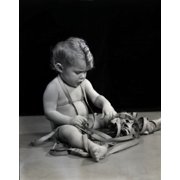 Naked baby playing with meter Canvas Art - 18 x 24