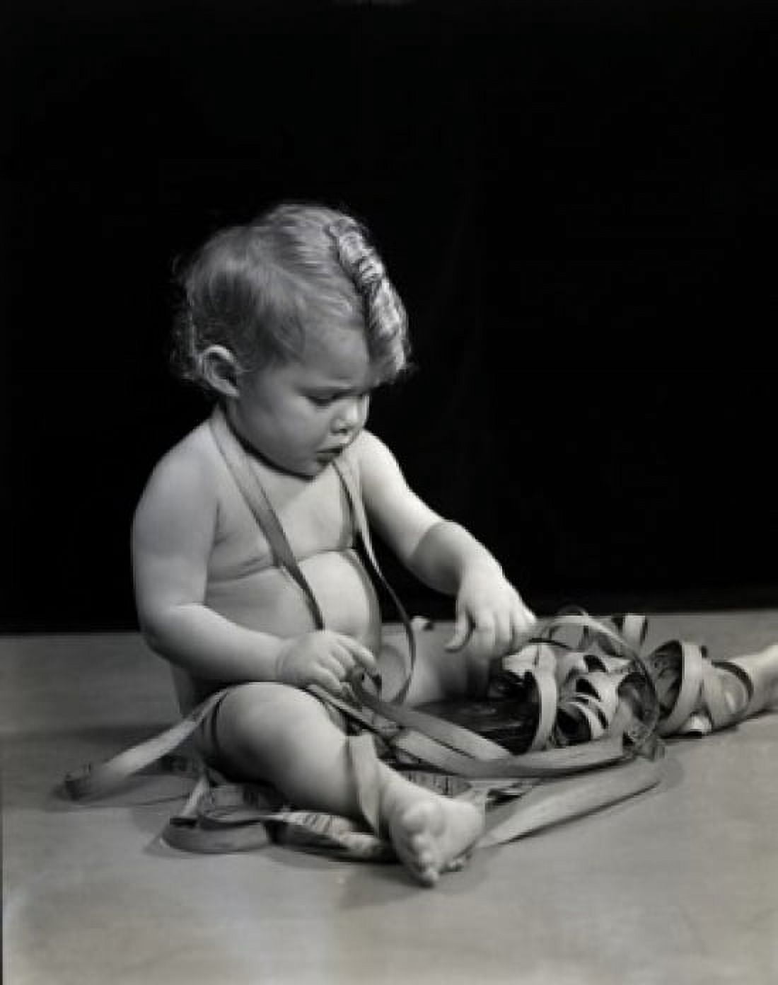 Naked baby playing with meter Canvas Art - (24 x 36)