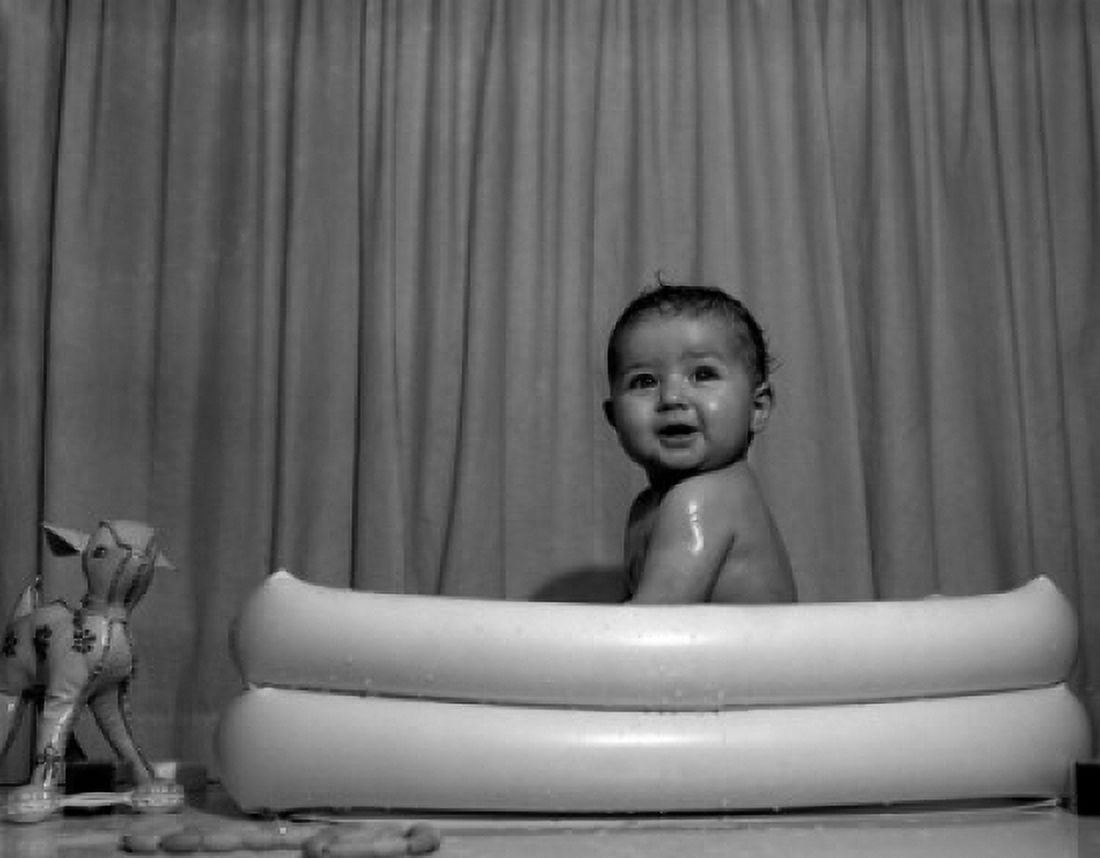 Naked baby sitting in wading pool Canvas Art - (24 x 36)