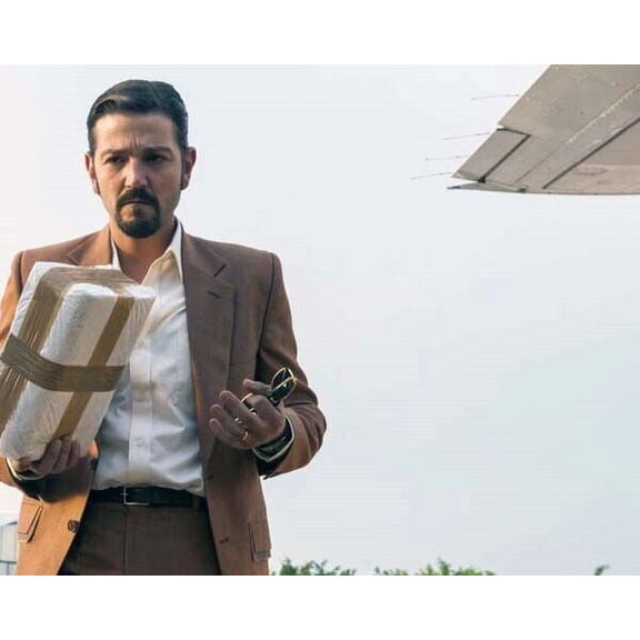 Narcos Mexico Diego Luna as Felix Gallardo in suit by airplane 8x10 inch photo