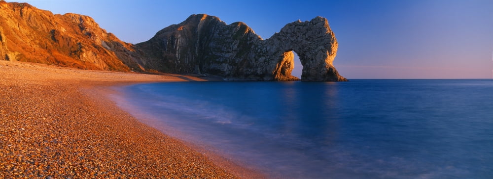 Natural arch on the beach Durdle Door Dorset England Canvas Art - Panoramic Images (27 x 9)