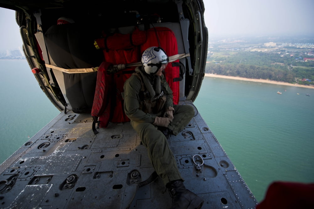 Naval Aircrewman surveys the Gulf of Thailand from an MH-60S Sea Hawk Canvas Art - Stocktrek Images (35 x 23)