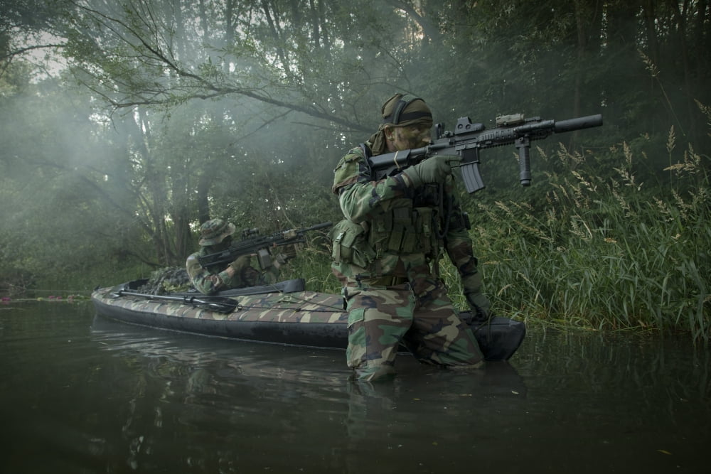 Navy SEALs navigate the waters in a folding kayak during jungle warfare operations Canvas Art - Tom WeberStocktrek Images (35 x 24)
