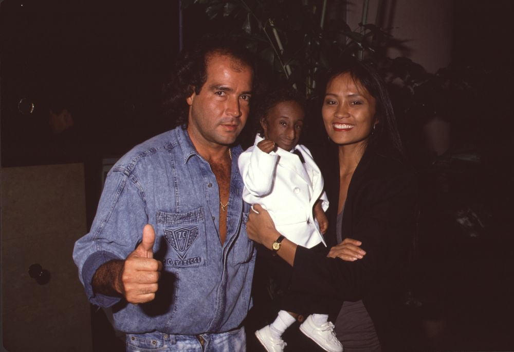 Nelson De La Rosa Being Held By Woman And Man In Denim Photo Print (16 x 20) - Item # CPA1655