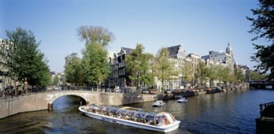 Netherlands Amsterdam tour boat in channel Canvas Art - Panoramic Images (24 x 12)