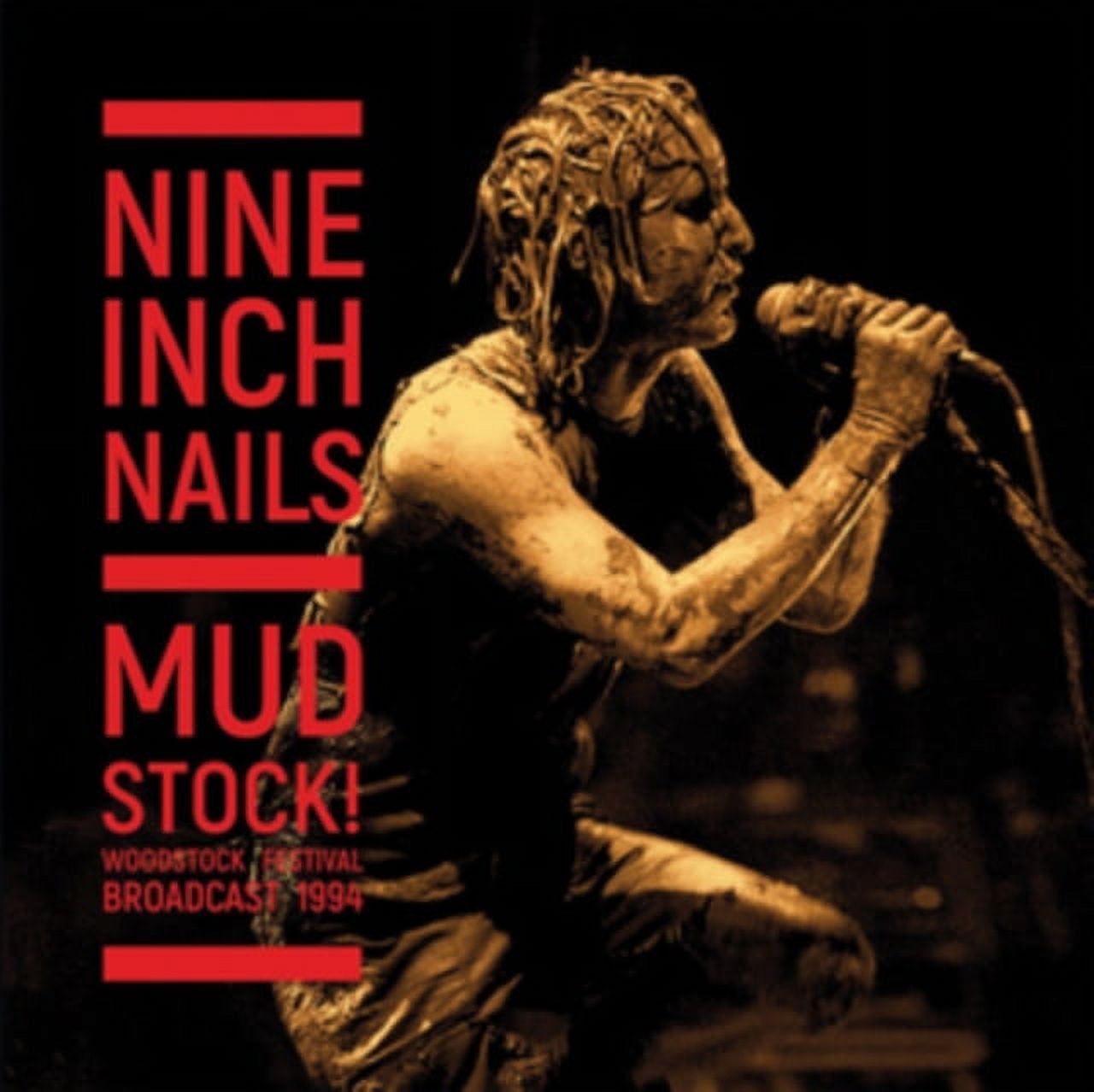 Trent Reznor, lead singer of Nine Inch Nails, performs covered in mud from  the afternoon downpour