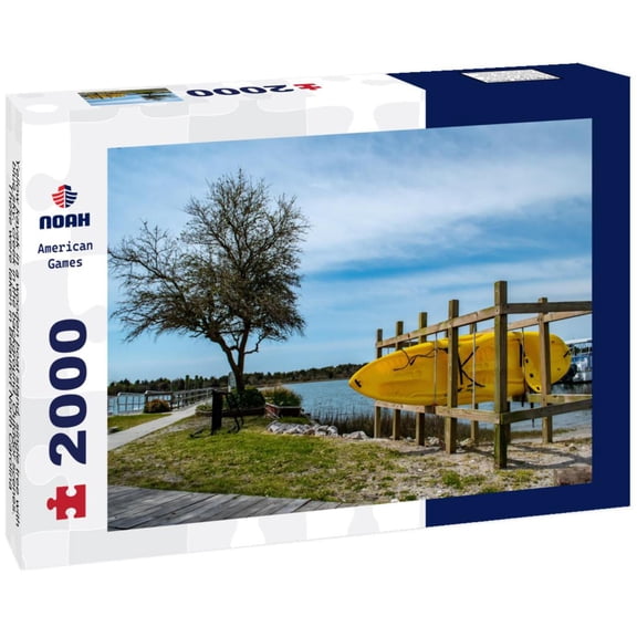 Yellow kayak in a wooden boat stand, single tree with blue sky, creek in the background. Outdoor scenes. These were taken in Beaufort North Carolina 2000pc Puzzle