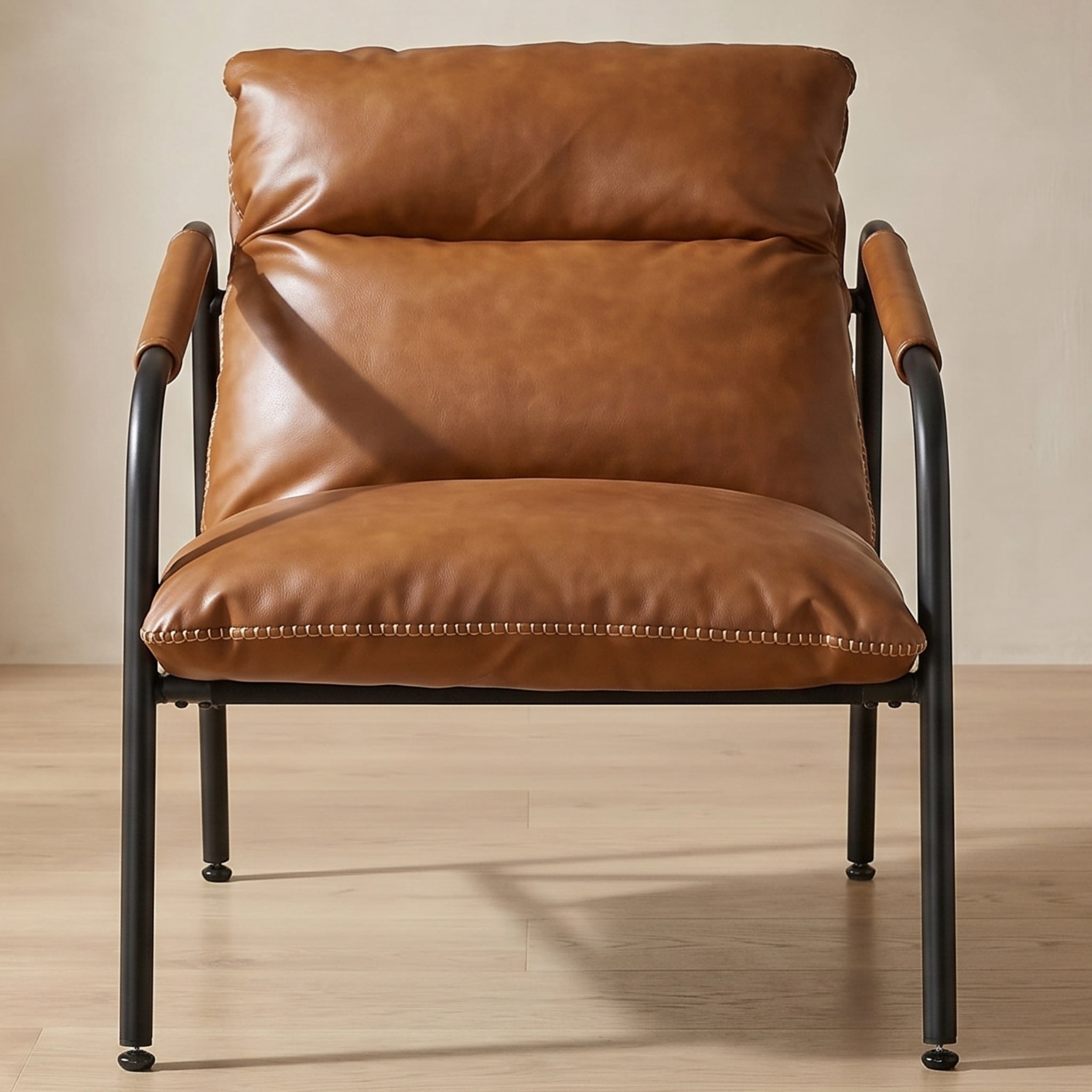 Nordic Hygge Mid-Century Modern Sling Armchair with Caramel Brown Synthetic Leather, Decorative Stitching, and Sturdy Metal Frame