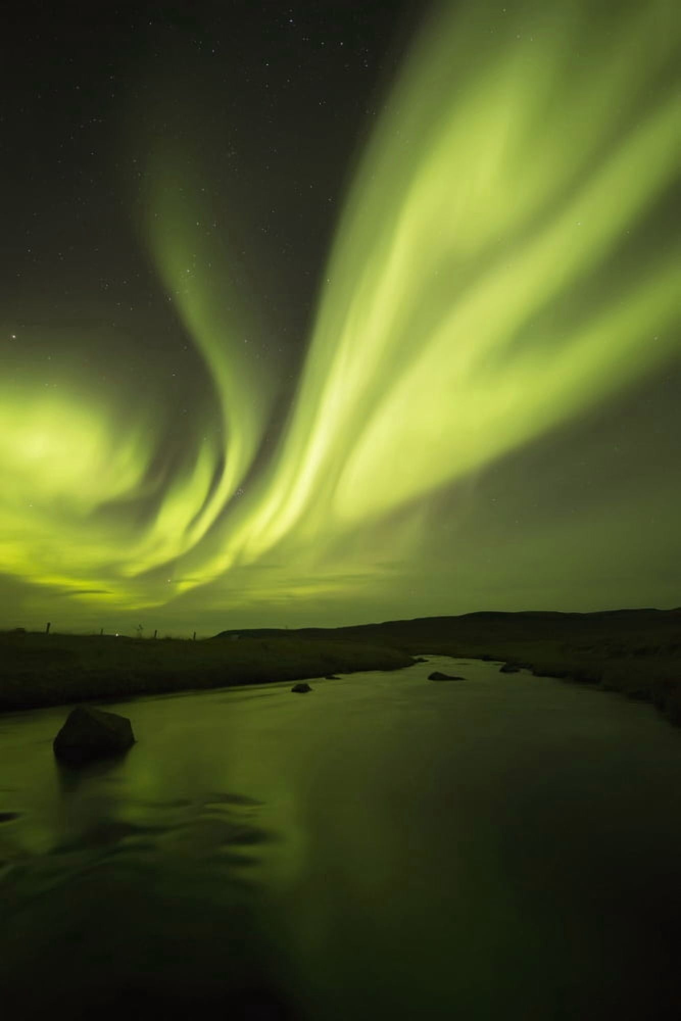 Northern Lights or Aurora Borealis glowing over a stream Iceland Canvas Art - Robert Postma Design Pics (12 x 19)