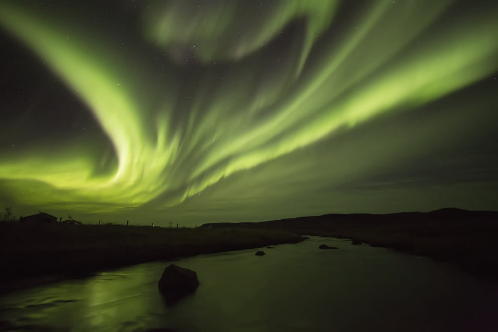 Northern Lights or Aurora Borealis glowing over a stream Iceland Canvas Art - Robert Postma Design Pics (19 x 12)