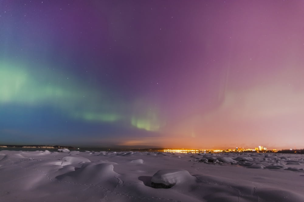 Northern lights shine above city skyline in this nighttime view from the tony knowles coastal trail in winterAnchorage alaska united states of america Canvas Art - Kevin Smith Design Pics (38 x 24)
