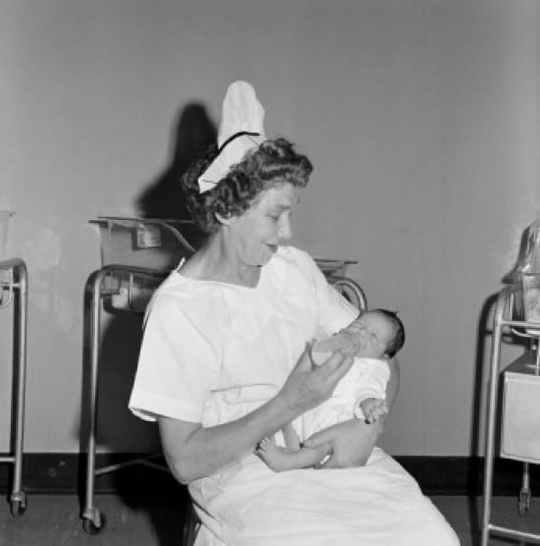 Nurse feeding newborn baby in hospital Canvas Art - (18 x 24)