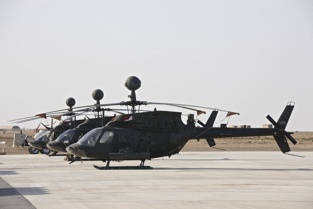 OH-58D Kiowa helicopters on the flight line at COB Speicher Iraq Canvas Art - Terry MooreStocktrek Images (35 x 23)