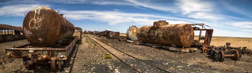 Old locomotives and rail cars at train cemetery Salar De Uyuni Altiplano Bolivia Canvas Art - Panoramic Images (27 x 9)