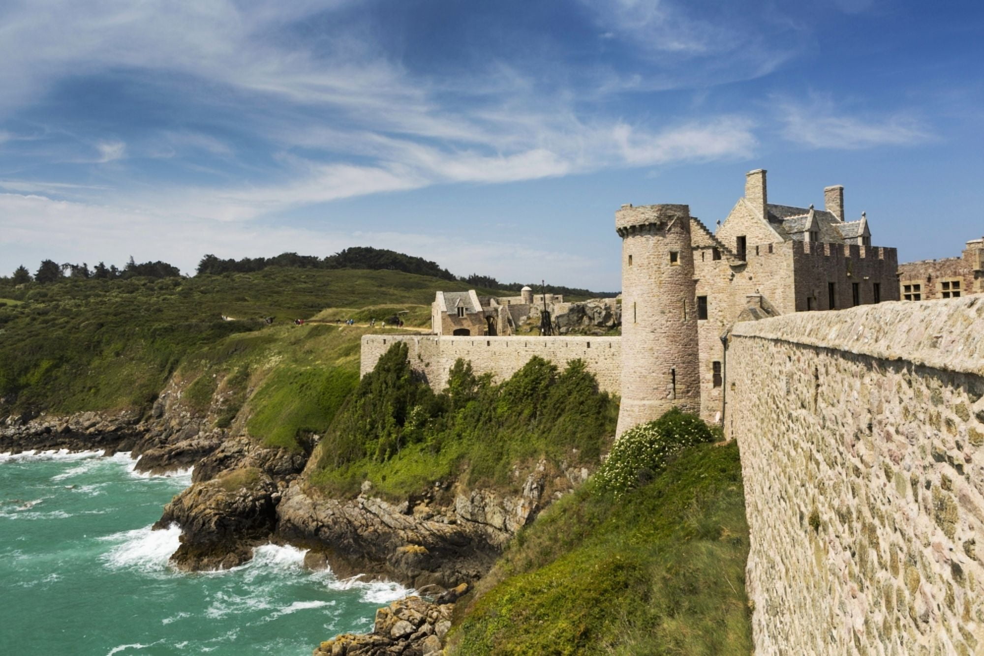 Old stone walled fort on hillside with turret on rocky shoreline along the sea with blue sky and clouds Plevenon Brittany France Canvas Art - Michael Interisano Design Pics (38 x 24)