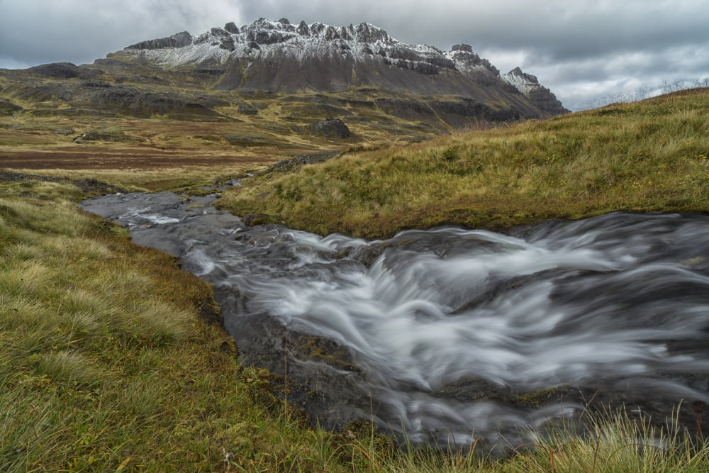 One of the numerous streams coming from the mountains in the West Fjords region of Iceland Iceland Canvas Art - Robert Postma Design Pics (38 x 24)
