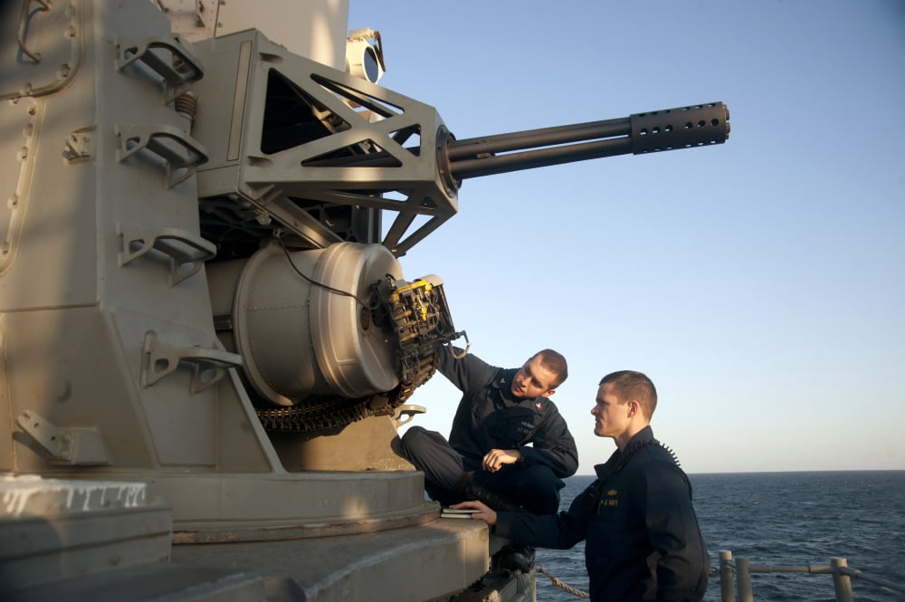 Operations Specialist and Ensign inspect a close-in weapons system Canvas Art - Stocktrek Images (34 x 23)