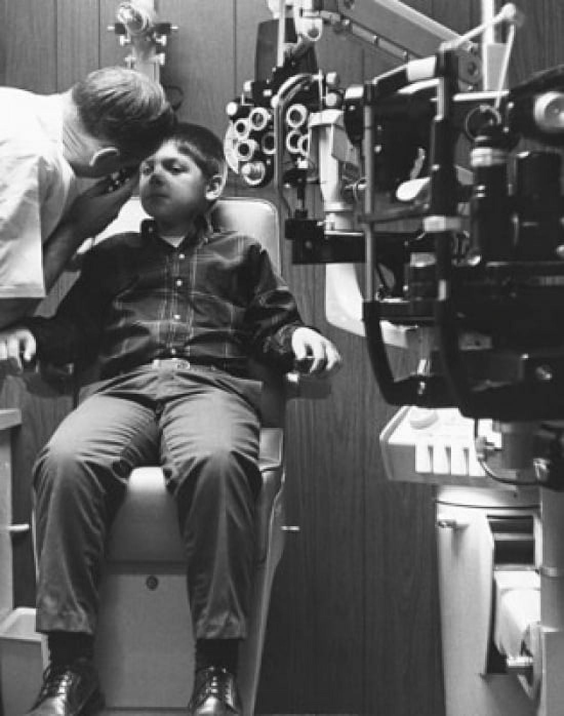 Optometrist examining a boys eye Canvas Art - (18 x 24)