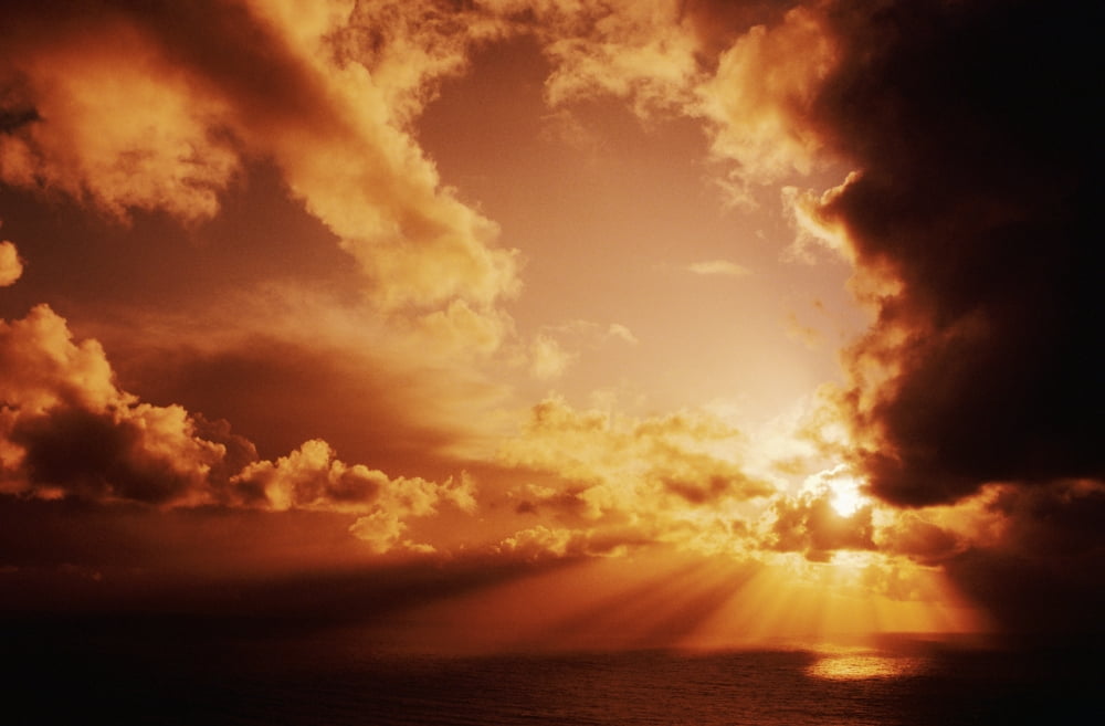 Orange Sunset Over Ocean Sunrays Bursting Through Puffy Clouds Canvas Art - Larry Dale Gordon Design Pics (17 x 11)