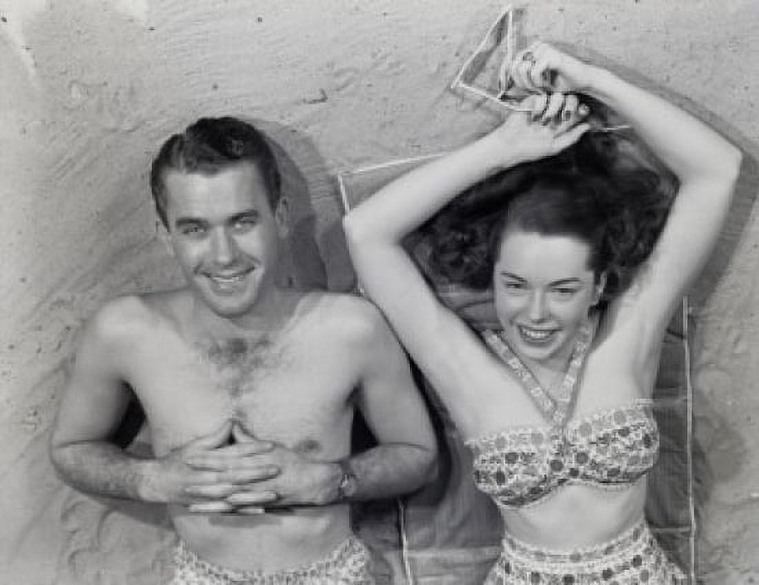 Overhead portrait of young couple relaxing on beach Canvas Art - (18 x 24)