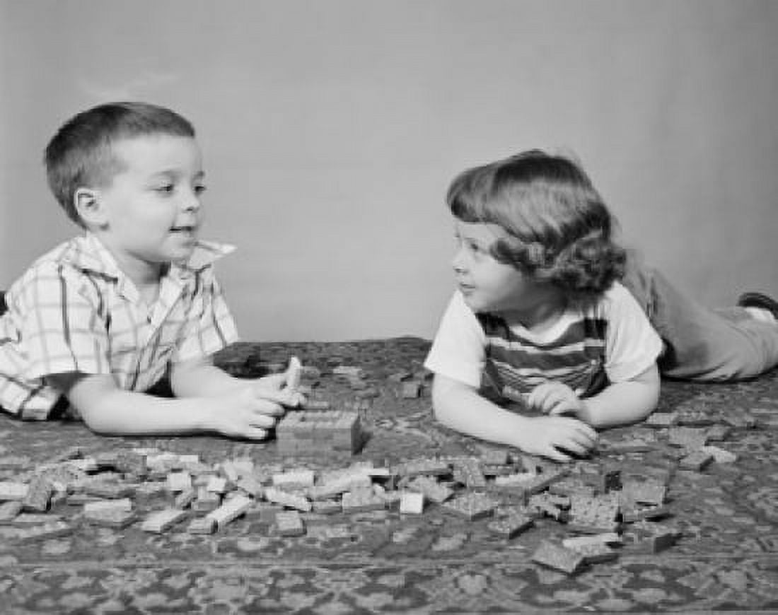 Pair of children playing with building blocks Canvas Art - (18 x 24)