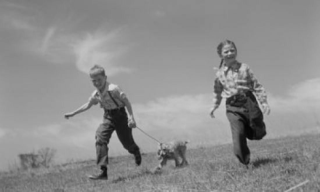 Pair of children running in field with dog Canvas Art - (24 x 36)