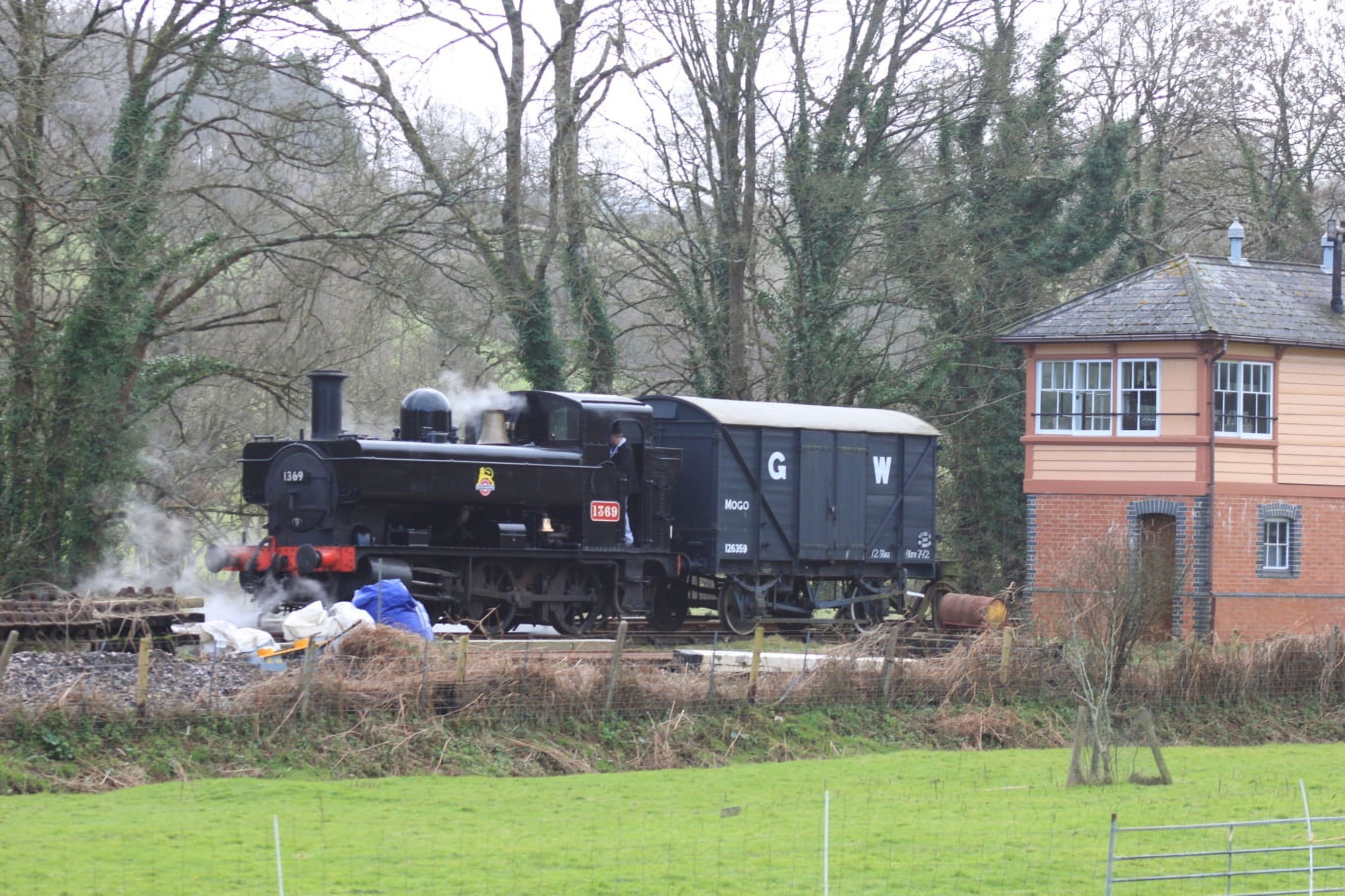 Pannier tank 1369 stands with a 'Mogo' motor car van in the siding by