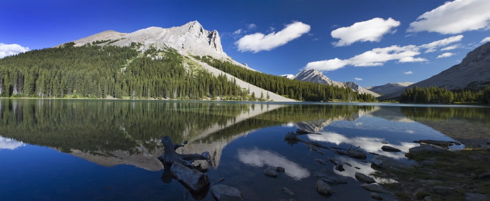 Panorama of a mountains reflecting on a mountain lake with blue sky and clouds in kananaskis provincial parkAlberta canada Canvas Art - Michael Interisano Design Pics (44 x 18)