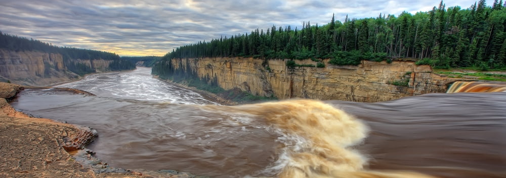 Panoramic Image Of The Hay River Falling Over Alexandra Falls With Hay River Gorge In Distance Near Hay River Northwest Territories Canvas Art - Robert Postma Design Pics (23 x 8)