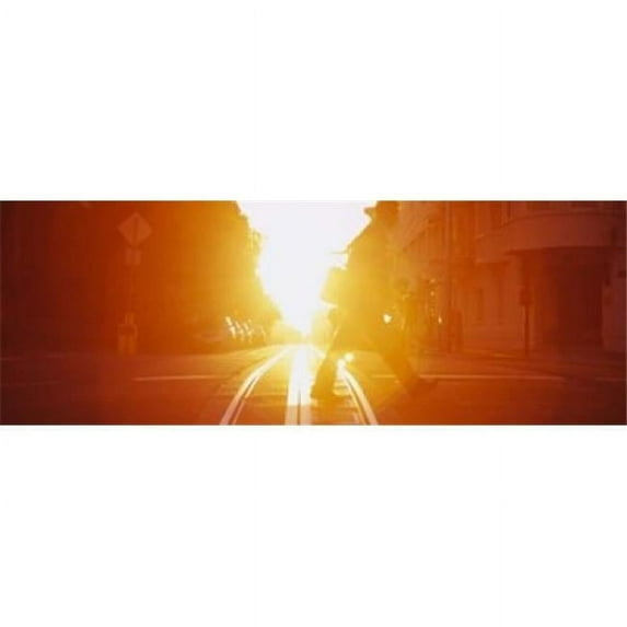 Panoramic Images Side profile of a person crossing the cable car tracks at sunset San Francisco California USA Poster Print by Panoramic Images - 36 x 12
