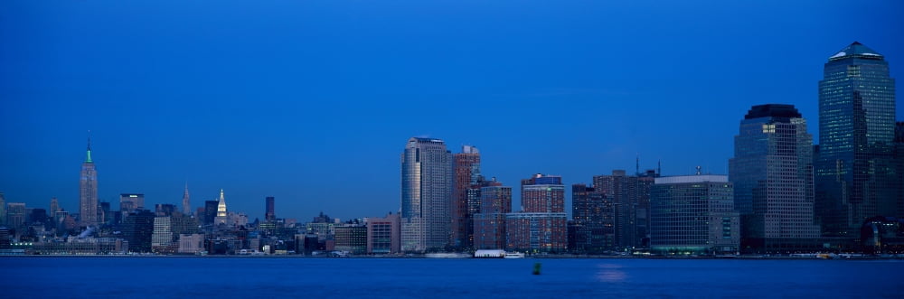 Panoramic night view of Empire State Building and Lower Manhattan skyline NY where World Trade Towers were located Canvas Art - Panoramic Images (36 x 12)