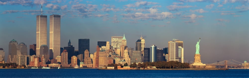 Panoramic sunset view of World Trade Towers Statue of Liberty Brooklyn Bridge and Manhattan NY skyline Canvas Art - Panoramic Images (27 x 9)