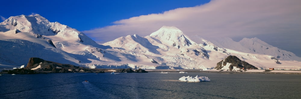 Panoramic view of ecological tourists in inflatable Zodiac boats snowy mountains glaciers and icebergs at Half Moon Island Bransfield Strait Antarctica Canvas Art - Panoramic Images (36 x 12)